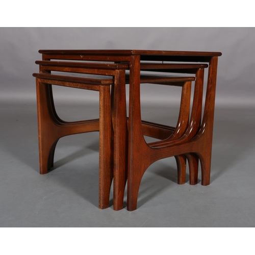 300 - A nest of three teak coffee tables, rectangular on curved 'H' standards, 57cm wide x 40cm deep x 48c... 