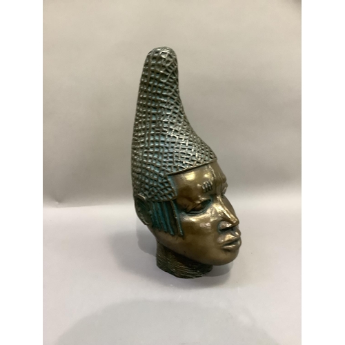 86 - A ceramic bust of tribal female, polished bronze-effect and verdigris finish, with elaborate head-dr... 