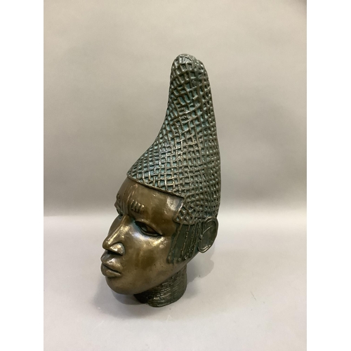 86 - A ceramic bust of tribal female, polished bronze-effect and verdigris finish, with elaborate head-dr... 