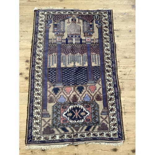 452 - A vintage prayer rug, the camel field with prayer niche and pillars in shades of blue and coral with... 