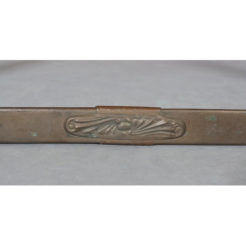 423 - A copper covered fire kerb, c.1915, with central and corner foliate embossed panels, 110cm wide x 35... 