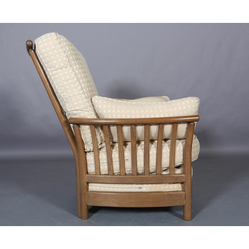 448 - An Ercol Light Golden Dawn armchair with slatted back and arms with fawn fabric cushions to the back... 