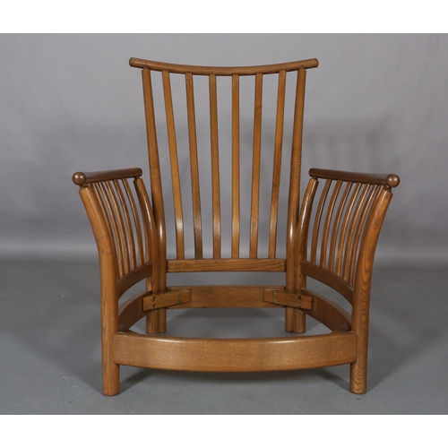 448 - An Ercol Light Golden Dawn armchair with slatted back and arms with fawn fabric cushions to the back... 