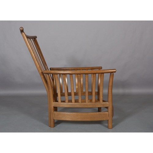 448 - An Ercol Light Golden Dawn armchair with slatted back and arms with fawn fabric cushions to the back... 