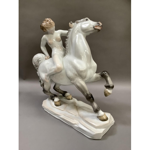 1 - A Herend porcelain figure of a nude female on horseback on a naturalistic rectangular plinth base, b... 