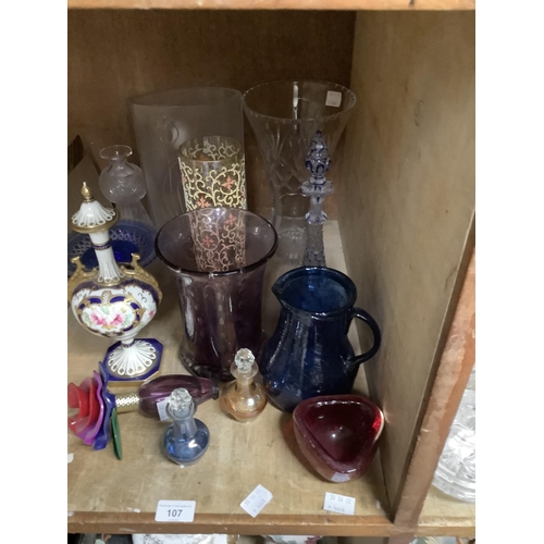 107 - Glassware including amethyst vase, blue jug, blue flashed and clear liqueur decanter, an amber cylin... 