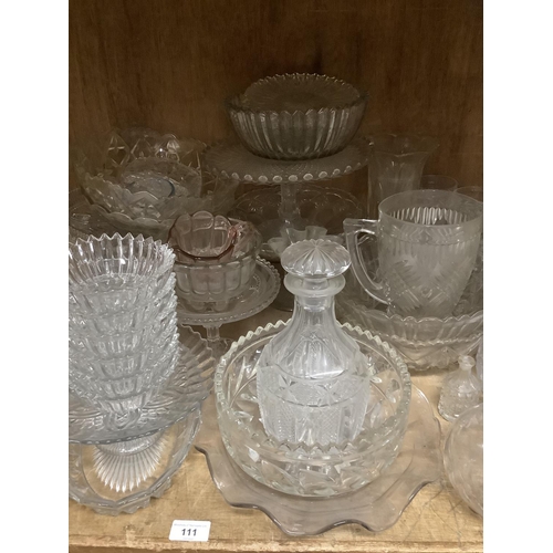 111 - A large quantity of moulded, cut, etched glassware including comports, bowls, decanters, vases, powd... 