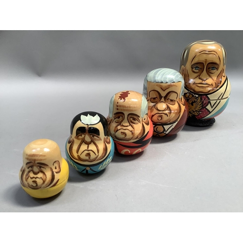 21 - A Russian doll set of seven each painted with a different Russian leader