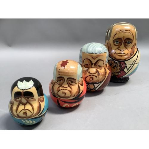 21 - A Russian doll set of seven each painted with a different Russian leader