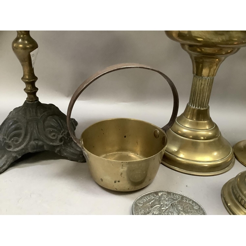 236 - A Victorian cast iron and brass trivet, a pair of brass candlesticks with drip trays and dished circ... 