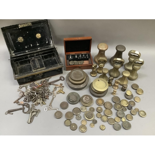 246 - A quantity of bell and other weights and a metal cash box containing a quantity of keys