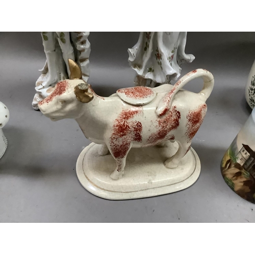 255 - A Victorian pottery cow creamer, figure of a dove, a fairing 'The last into bed puts out the light',... 