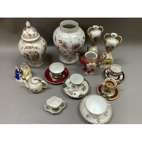 260 - A pair of Dresden style two handled vases raised on plinths, cups and saucers, individual teapot etc