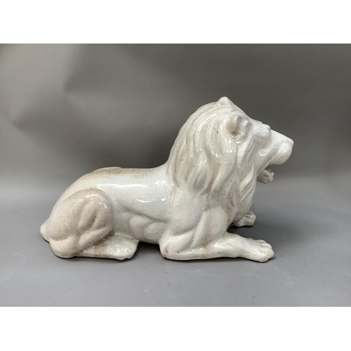 280 - A crackle glaze pottery figure of a recumbent lion , approximately 47cm long x 32cm high