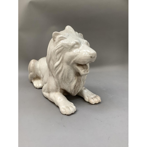 280 - A crackle glaze pottery figure of a recumbent lion , approximately 47cm long x 32cm high