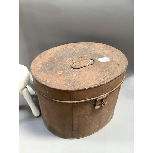 284 - A vintage tin hat box of oval outline together with a dolly peg