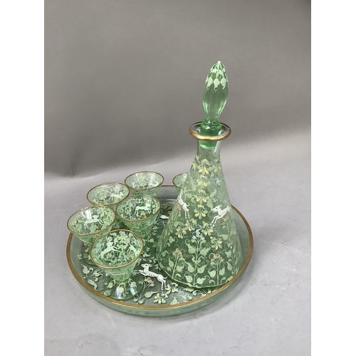 288 - An Art Deco liqueur set of pale green glass, enamelled with running antelope amongst scrolling leafa... 