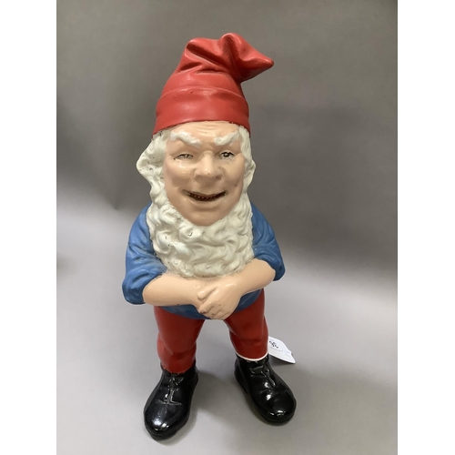 36 - A vintage garden gnome painted in red, white, blue and black, measuring 18.5cm