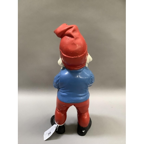 36 - A vintage garden gnome painted in red, white, blue and black, measuring 18.5cm