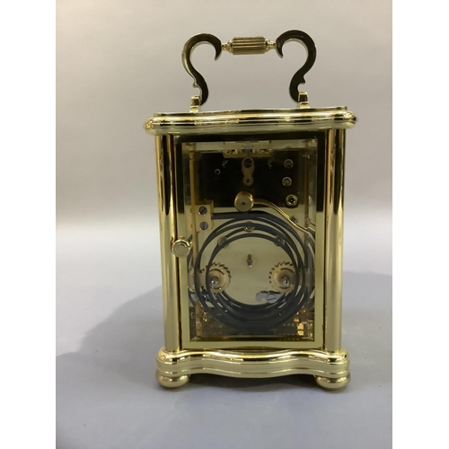 41 - A hand polished brass carriage clock by Matthew Norman having a white enamel dial with Roman numeral... 