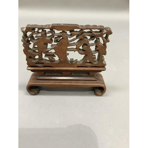 53 - A Chinese carved and pierced boxwood panel of figures on a stand, overall 12.5cm by 10.5cm