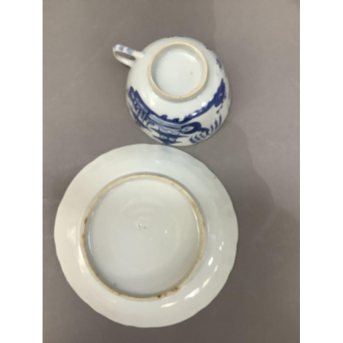 55 - A Chinese blue and white cup and saucer painted with a pagoda and island scene