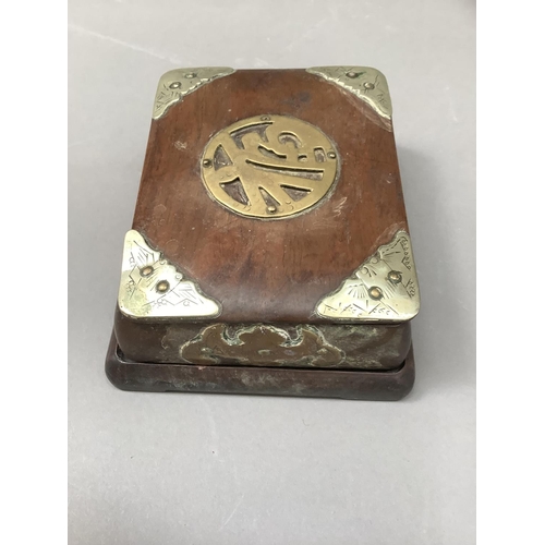 65 - A Chinese hardwood box, cover and stand mounted with brass character to the cover, battle emblems to... 