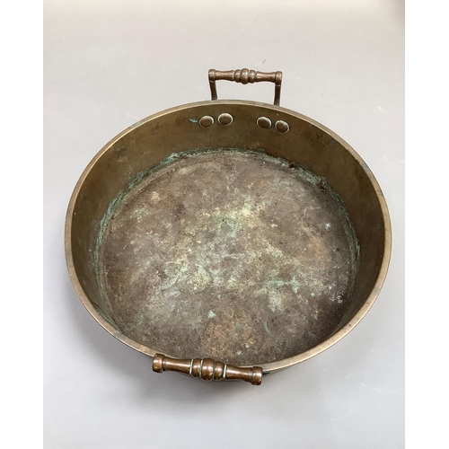 73 - A 19th century brass two handled pan, 37cm diameter over handles , 9cm to the lip