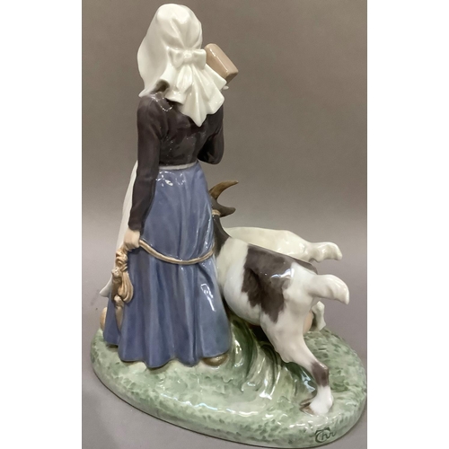 100 - A Royal Copenhagen group of a girl with goats,
printed and painted mark to underside, 25cm high x 21... 