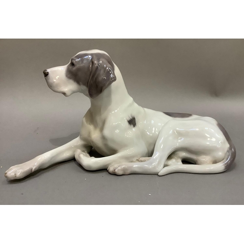 102 - A Royal Copenhagen figure of a recumbent gun dog, printed and painted marks to underside
13cm high x... 