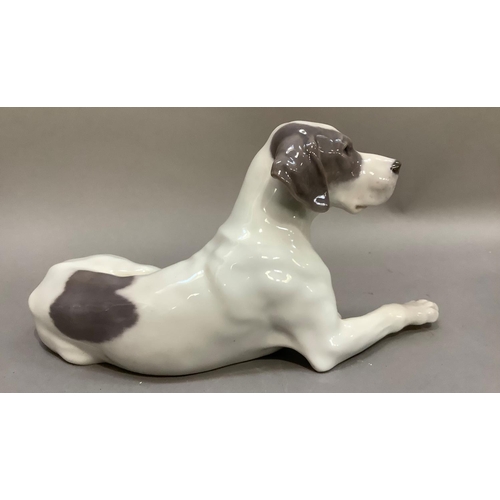 102 - A Royal Copenhagen figure of a recumbent gun dog, printed and painted marks to underside
13cm high x... 