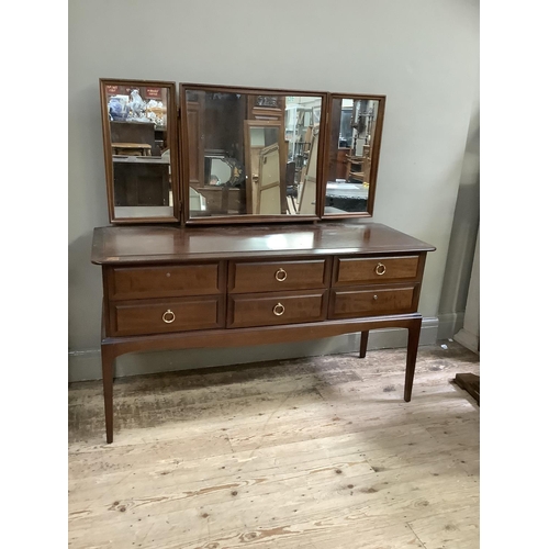 151 - A Stag Minstrel dressing table with triple mirrors and two rows of three drawers, 132cm wide by 72cm... 