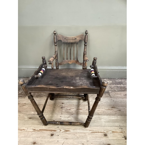 164 - An early 20th century child's high chair with rail back and turned framing, converting to a play cha... 