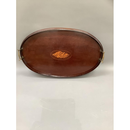 313 - An Edwardian mahogany two handled tray of oval outline inlaid to the centre in satinwood with a shel... 