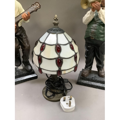 332 - A pair of reproduction figures of Musicians and a reproduction Tiffany lamp