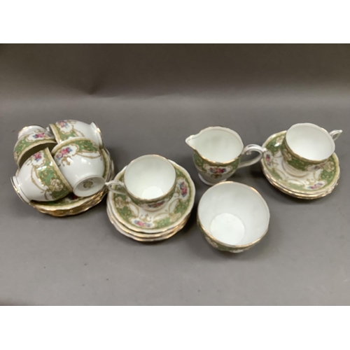 336 - A green and gilt on white tea service by Queen Anne China of Regency pattern