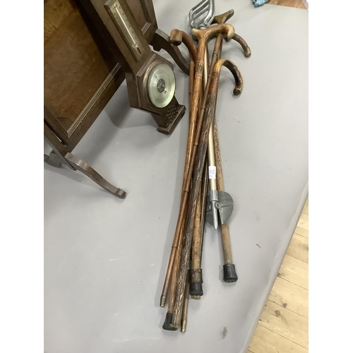 350 - A quantity of walking sticks and a shooting stick and an oak cased thermometer-barometer and a foldi... 