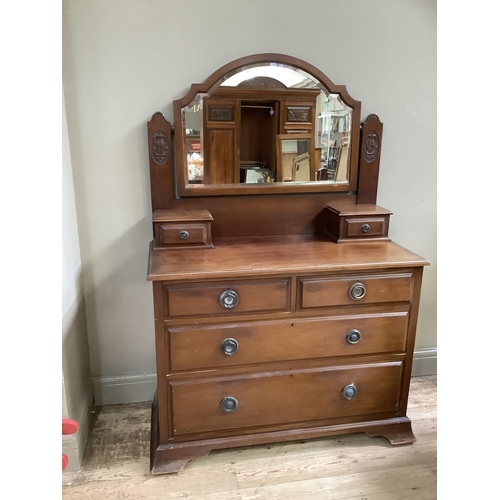 410 - An Edwardian mahogany dressing chest with arched bevelled mirror, two short and two long drawers, wi... 