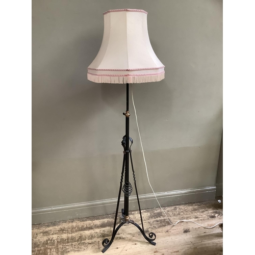 412 - An Art Nouveau wrought iron and copper standard lamp with telescopic column, with shade