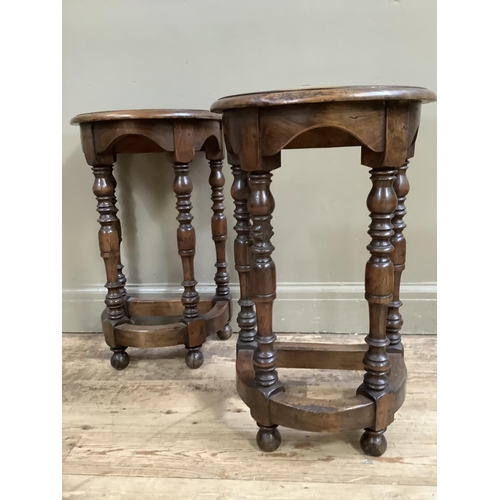 414 - A pair of reproduction fruitwood hall tables, demi lune, on four baluster turned legs joined by a st... 