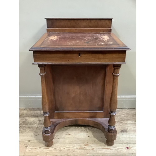 420 - A Victorian walnut Davenport having a raised stationery compartment above a leather incised slope, t... 