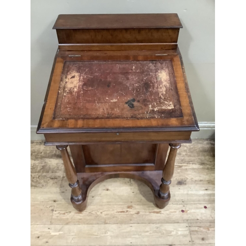 420 - A Victorian walnut Davenport having a raised stationery compartment above a leather incised slope, t... 