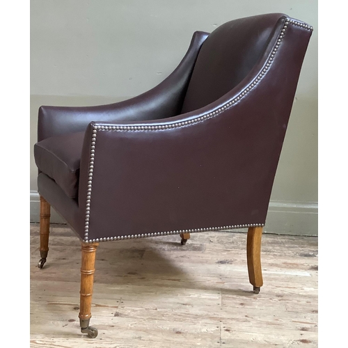 421 - A reproduction  library chair of George IV style, upholstered in dark brown hide with close nail stu... 