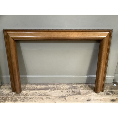 422 - A 1930s mahogany fire surround, cushion moulded, 149cm wide x 96cm high, the inner measurements 116c... 