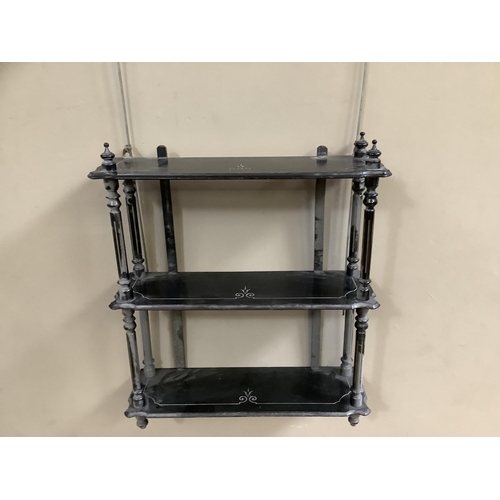 436 - A Victorian ebonised wall shelf of three tiers with gilt highlighting and turned uprights