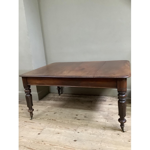 443 - A Victorian mahogany dining table, rectangular with rounded corners, on inverted tulip and turned le... 