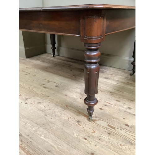 443 - A Victorian mahogany dining table, rectangular with rounded corners, on inverted tulip and turned le... 