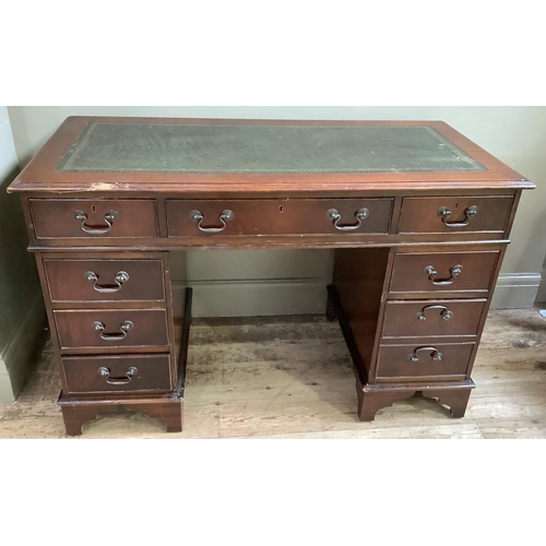 447 - A reproduction mahogany knee hole desk, repaired to the front, 122cm wide x 62cm deep