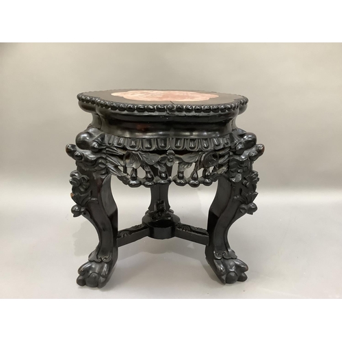 454 - A Chinese hardwood and marble inset urn stand circular scalloped outline on three carved legs, 31cm ... 