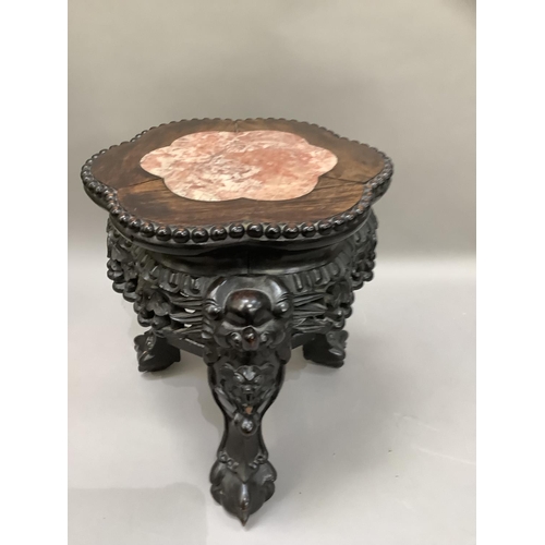 454 - A Chinese hardwood and marble inset urn stand circular scalloped outline on three carved legs, 31cm ... 